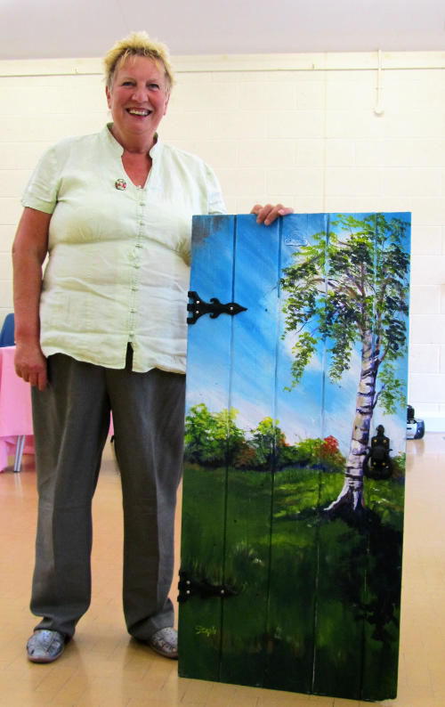 Steph with a picture painted on an old door