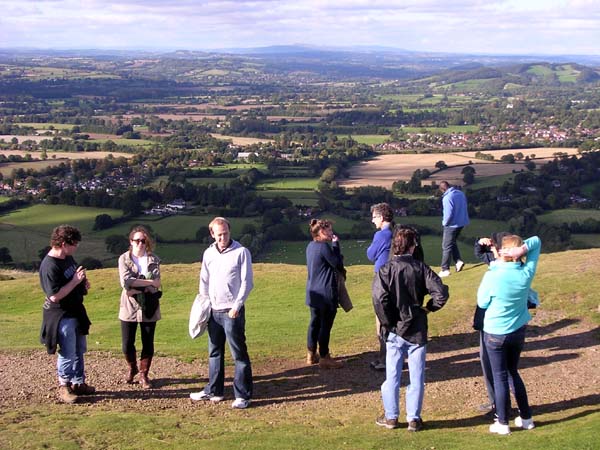 A group on a hillside with a view far into the distance