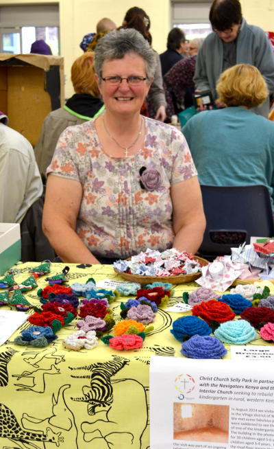Bobbie sitting behind a stall selling crafts