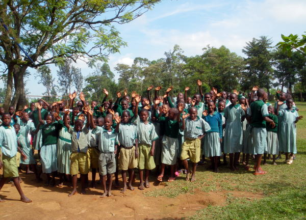 A crowd at the school all waving