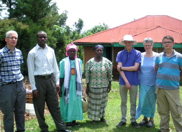 Family group outside a house in Chris Amulo's village