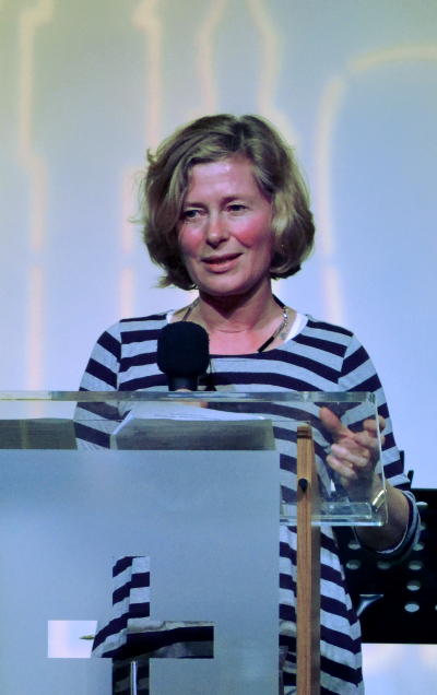 Judy speaking at a lectern