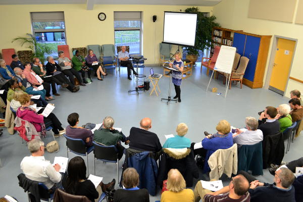 The audience in a circle as Judy speaks