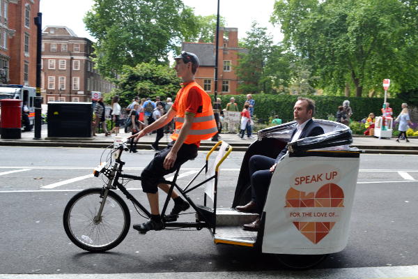 An MP in a cycle rickshaw