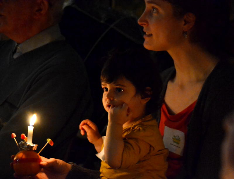 Faces and a Christingle candle