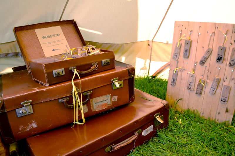 A pile of suitcases in a tent