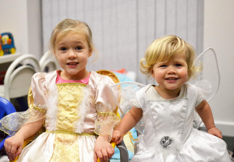 Two angels sitting in chairs