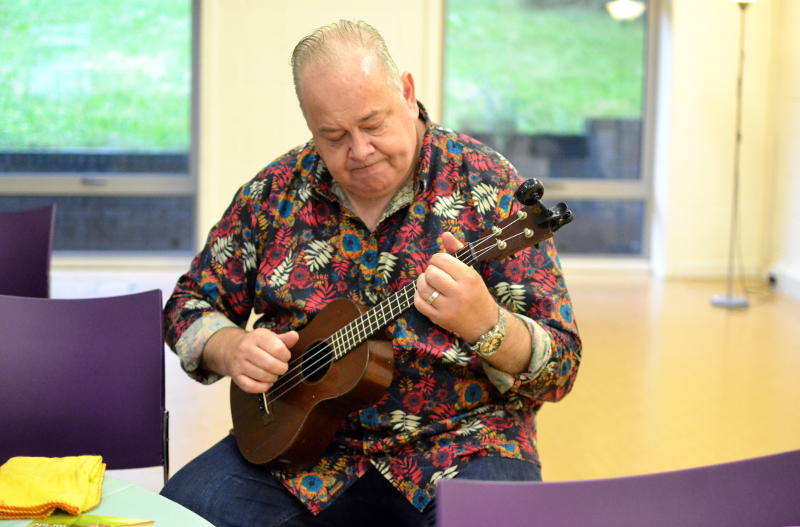 John Archer practising the ukulele