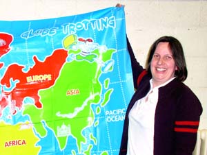 Amanda holding a map of the world