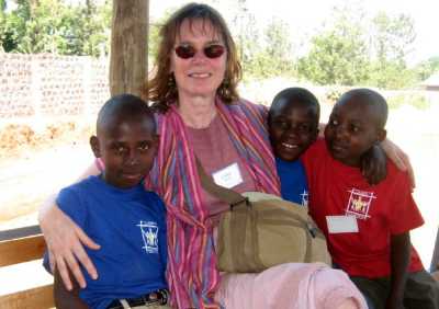 Cathie sitting with some Tanzanian boys