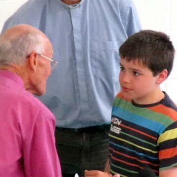 A boy tells the Bishop he is ready to be baptised