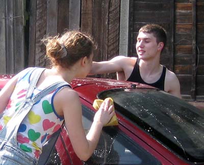 Beccy and Dan washing a car