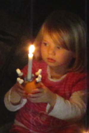 A Christingle with lighted candle