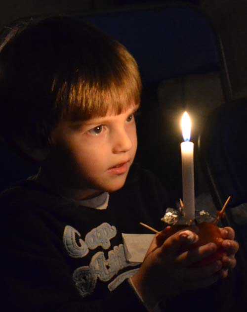 A Christingle with lighted candle