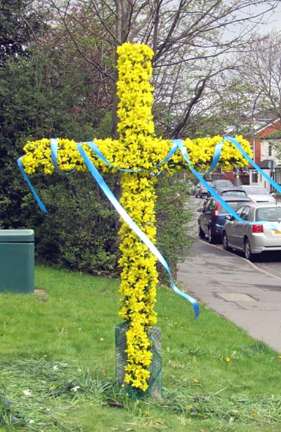 The cross outside Christ Church decorated with flowers