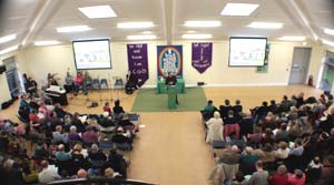 Aerial view of the main hall with people gathered for the service