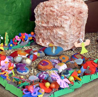 An Easter garden containing many painted stones