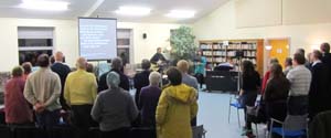 People standing to sing in worship