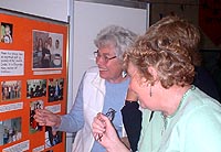 Present church members looking at photos from the early days of the Church Centre