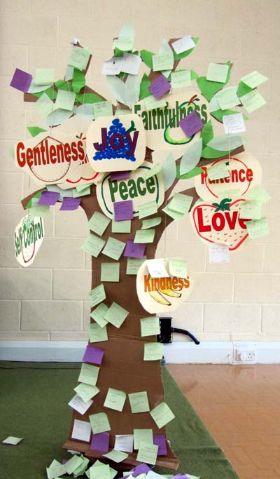 A cardboard tree decorated with the fruit of the Spirit and sticky notes