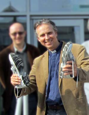 Geoff Lanham holding a pair of running shoes