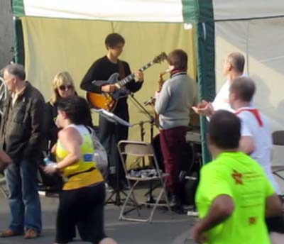 A jazz band plays by the roadside