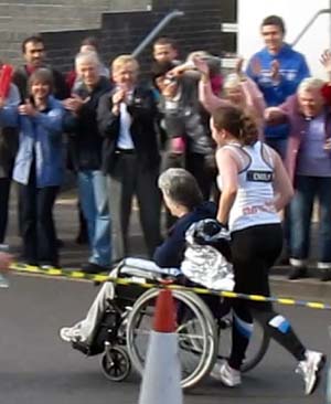 A daughter pushes her mother in a wheelchair