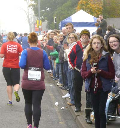 A crowd of spectators lined up along the pavement