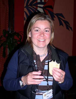 Helen Tomblin holding a glass of wine and a sandwich