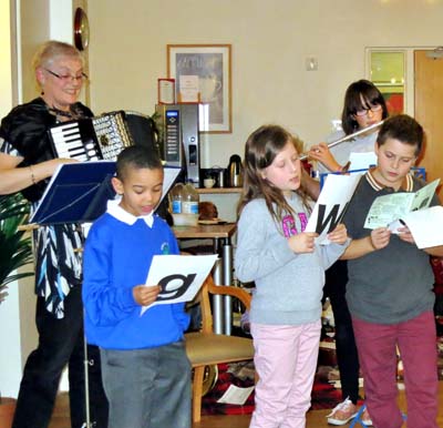 A group singing to the accompaniment of an accordion
