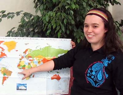Natalie in front of a world map
