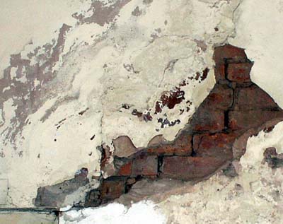 Damaged plaster and brickwork