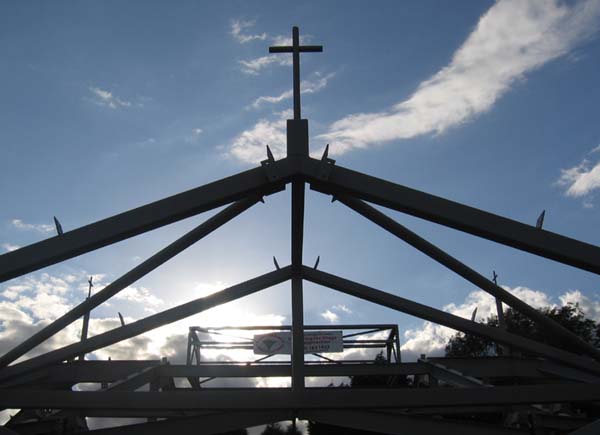 A framework of metal girders topped by a cross