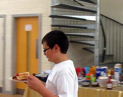 A member of Reloaded carries a well-laden plate