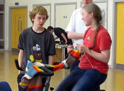 One of the cyclists knitting a scarf