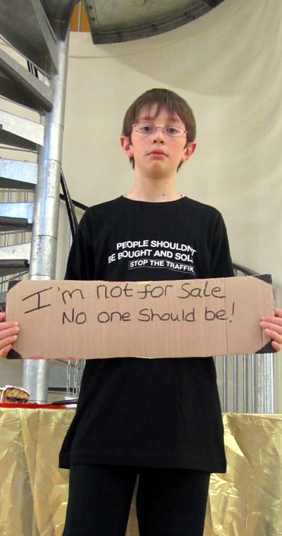 Holding a sign: I'm not for sale - no-one should be