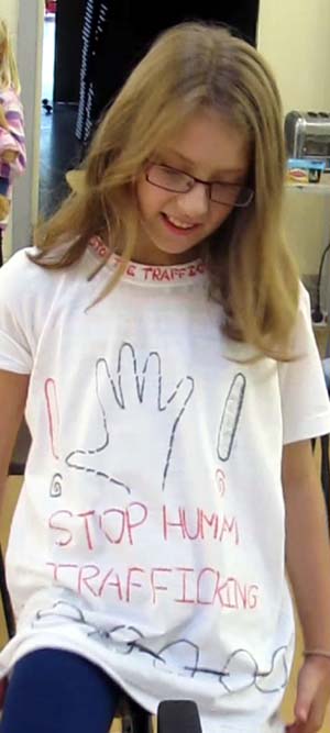 A cyclist wears a Stop Human Trafficking T-shirt