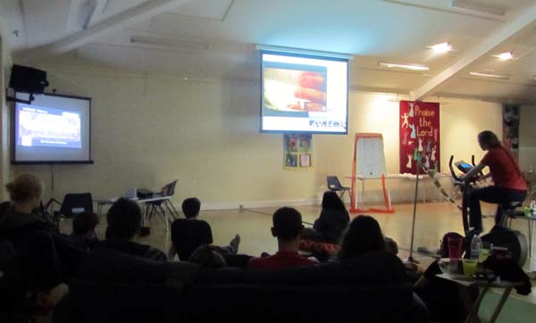 The Reloaded youth group watch a video about human trafficking in the darkened main hall
