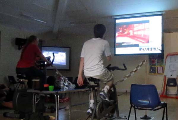 Riding an exercise bike in near darkness