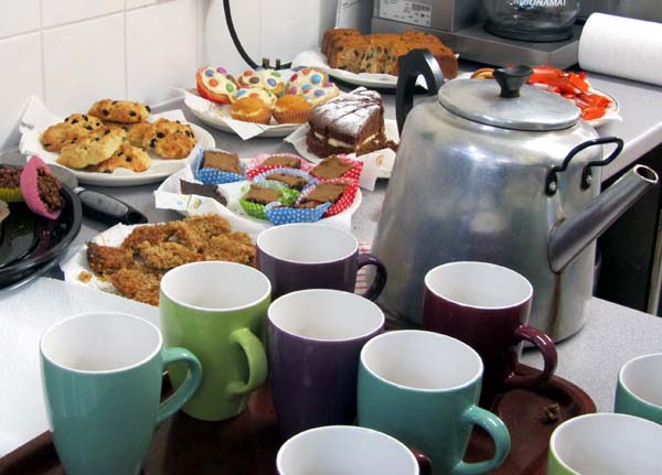 A teapot, cups and cakes