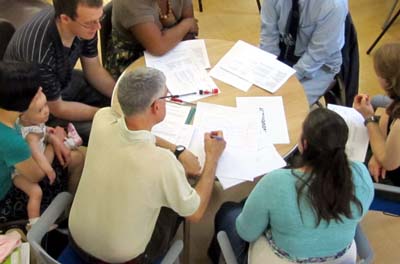 Looking down on a group of people studying papers around a table